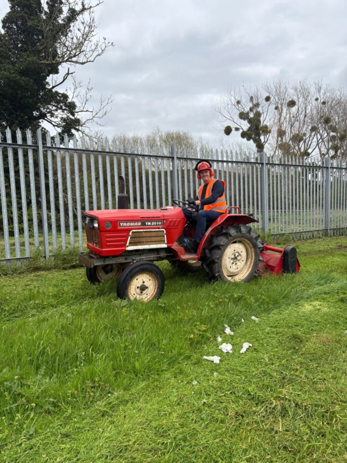 Cutting back overgrown grass on a commercial site